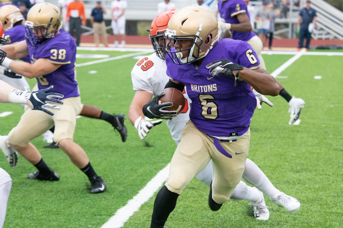 Member of the Southern Technical University football team running with a football during a game.